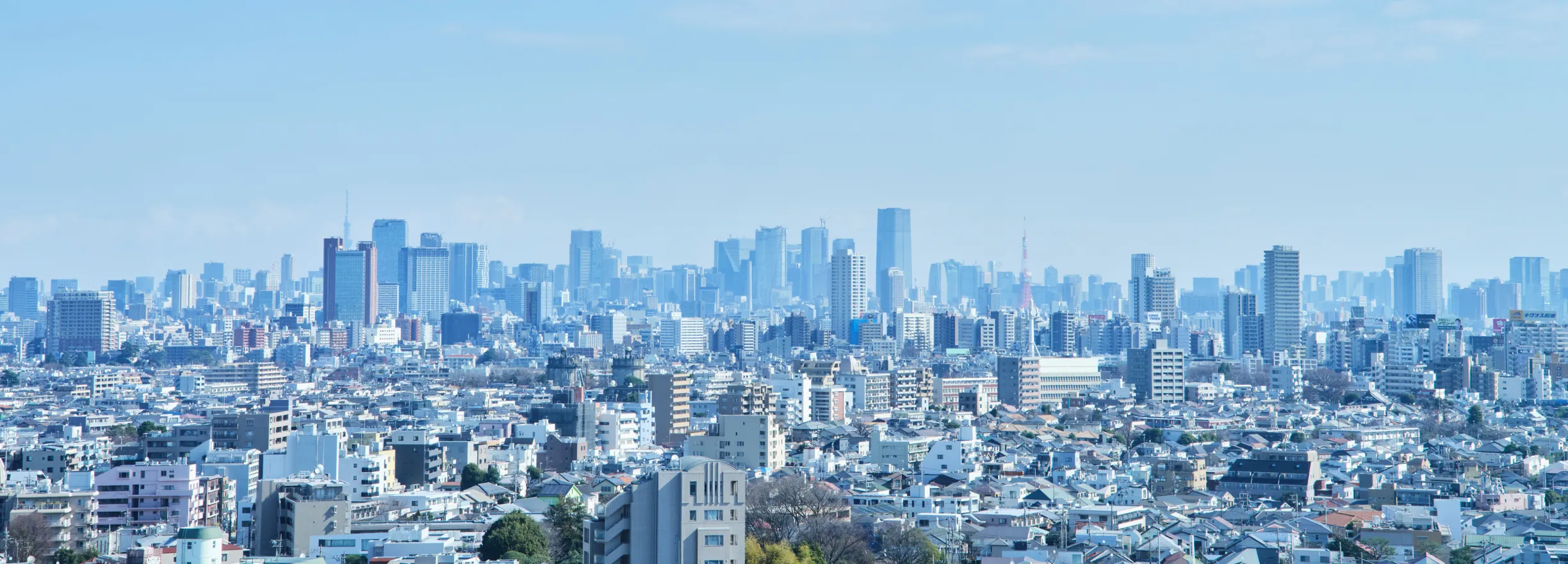 A panoramic view of the cityscape, with skyscrapers and residential areas.